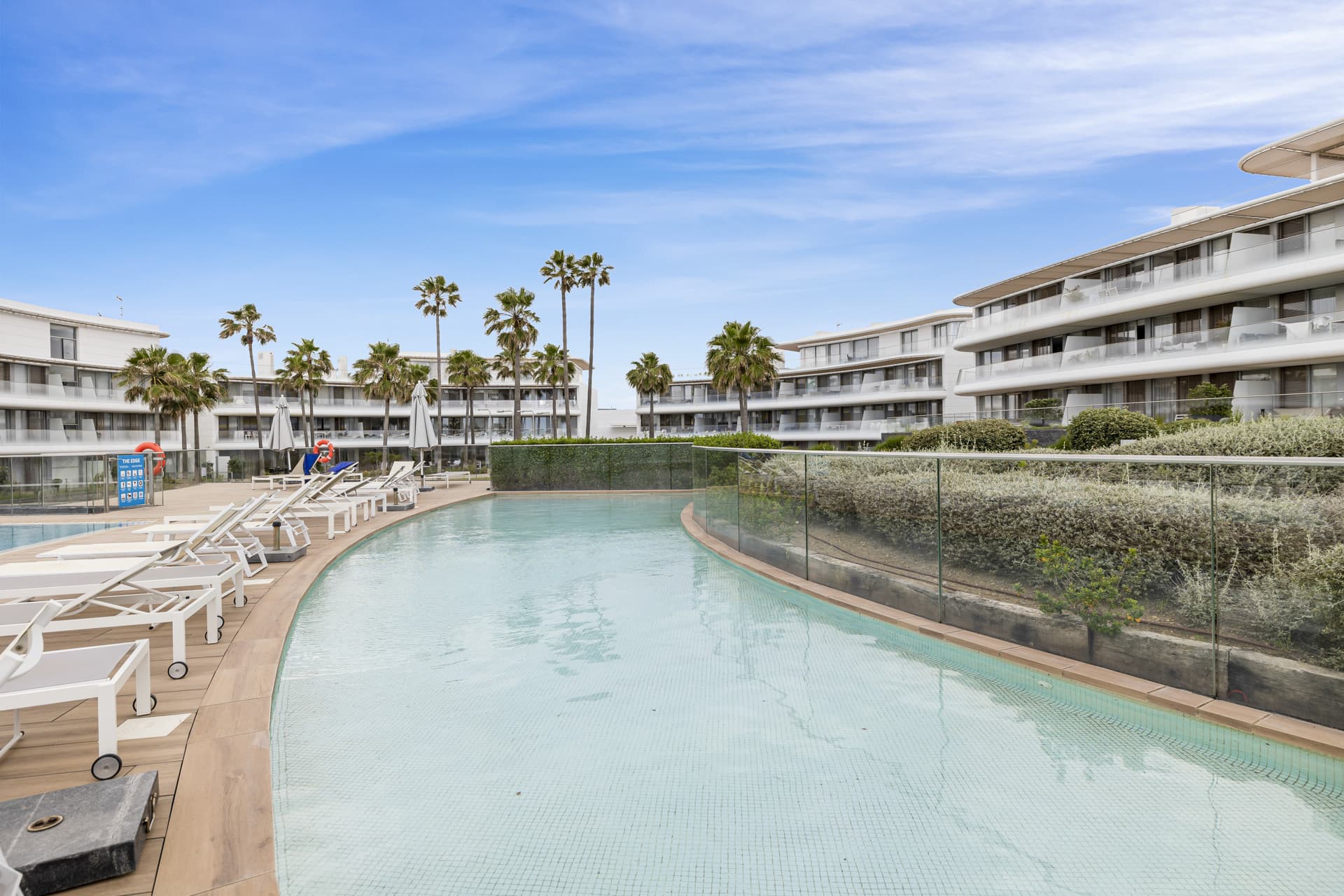 This elegant ground-floor apartment offers a refined coastal lifestyle within an exclusive beachfront setting