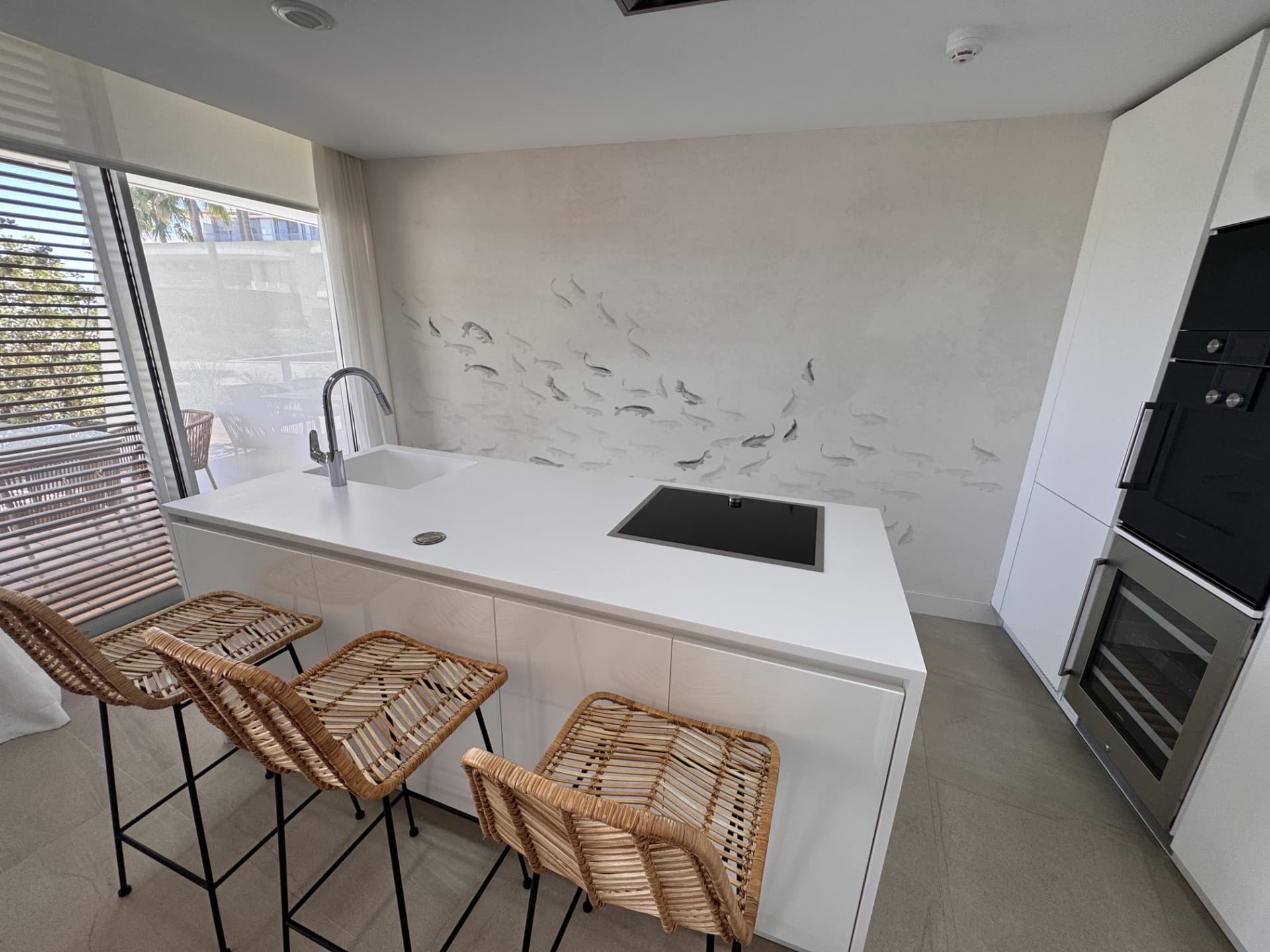 This elegant ground-floor apartment offers a refined coastal lifestyle within an exclusive beachfront setting