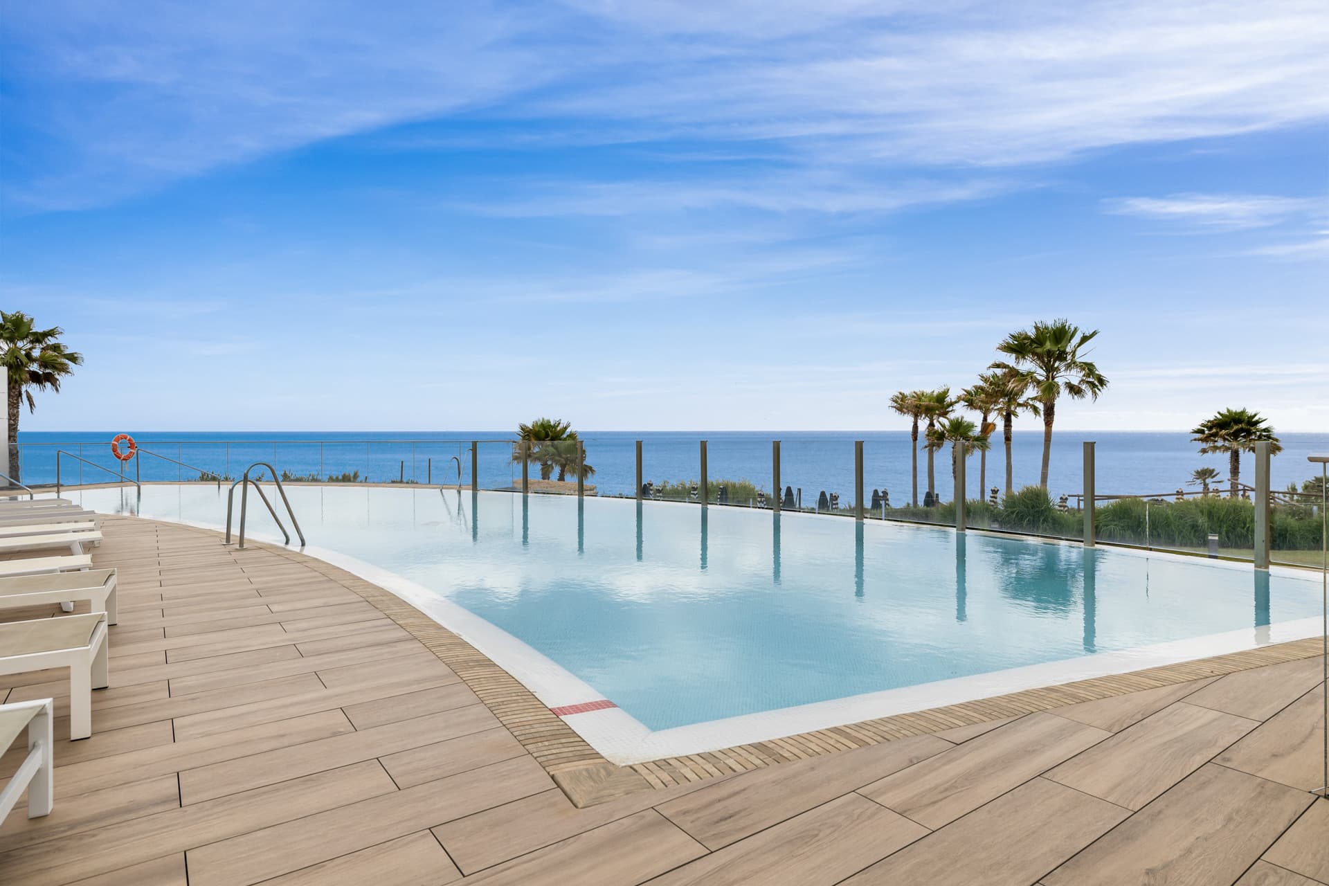 This elegant ground-floor apartment offers a refined coastal lifestyle within an exclusive beachfront setting