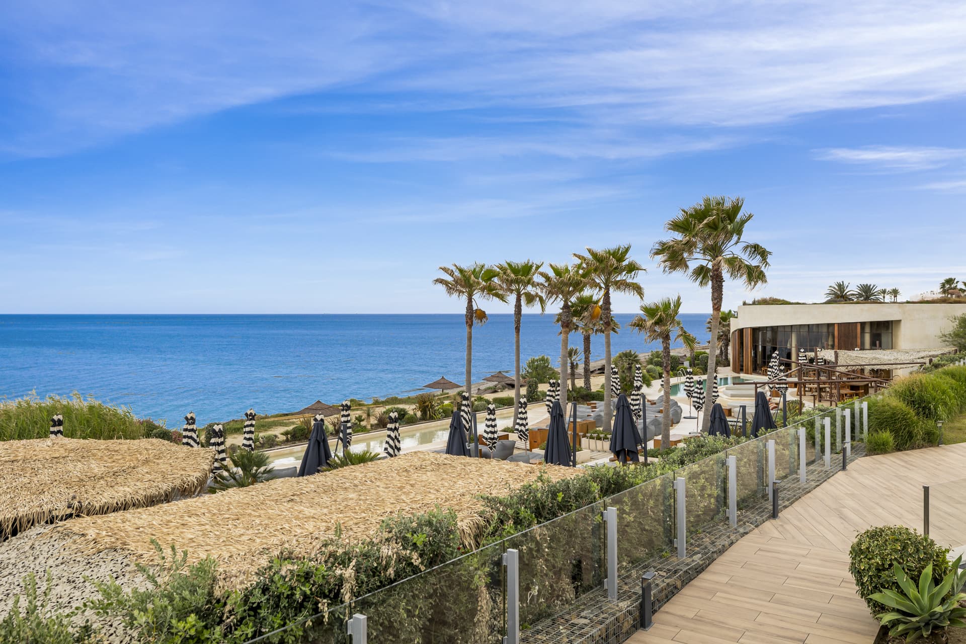 This elegant ground-floor apartment offers a refined coastal lifestyle within an exclusive beachfront setting